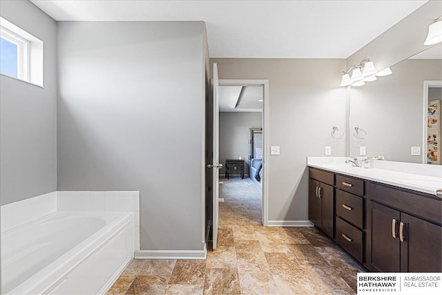 20904 Camden Ave, Omaha, NE 68022 - bathroom with double vanity, a garden tub, ensuite bath, and baseboards