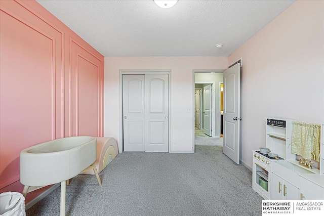20904 Camden Ave, Omaha, NE 68022 - bedroom with light colored carpet, a closet, baseboards, and a textured ceiling
