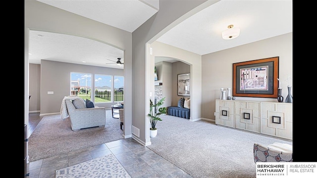 20904 Camden Ave, Omaha, NE 68022 - carpeted entrance foyer with arched walkways, a ceiling fan, and baseboards