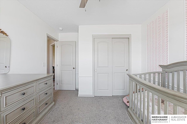 20904 Camden Ave, Omaha, NE 68022 - bedroom with light carpet, a closet, a crib, and ceiling fan