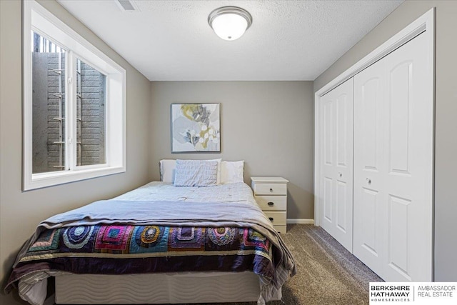 20904 Camden Ave, Omaha, NE 68022 - carpeted bedroom featuring a closet, a textured ceiling, and baseboards