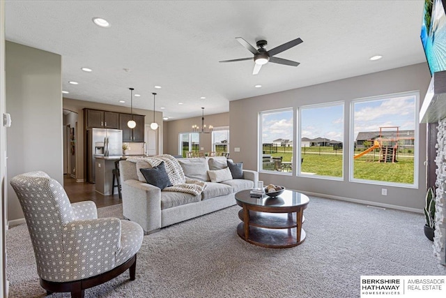 20904 Camden Ave, Omaha, NE 68022 - living area with a chandelier, a ceiling fan, recessed lighting, dark colored carpet, and baseboards