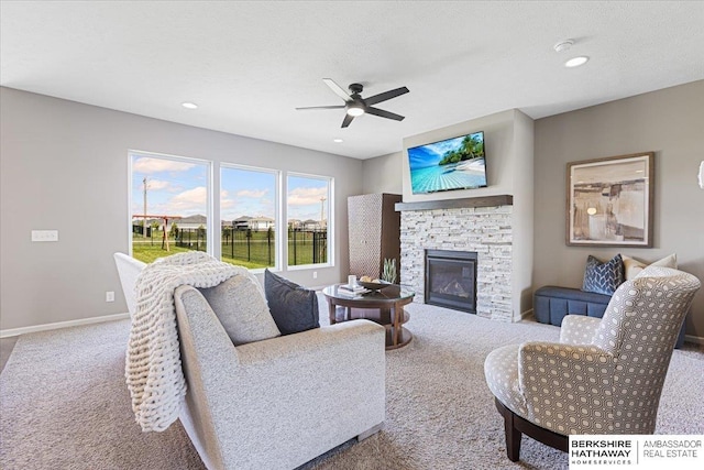 20904 Camden Ave, Omaha, NE 68022 - living area featuring carpet flooring, ceiling fan, a stone fireplace, baseboards, and recessed lighting