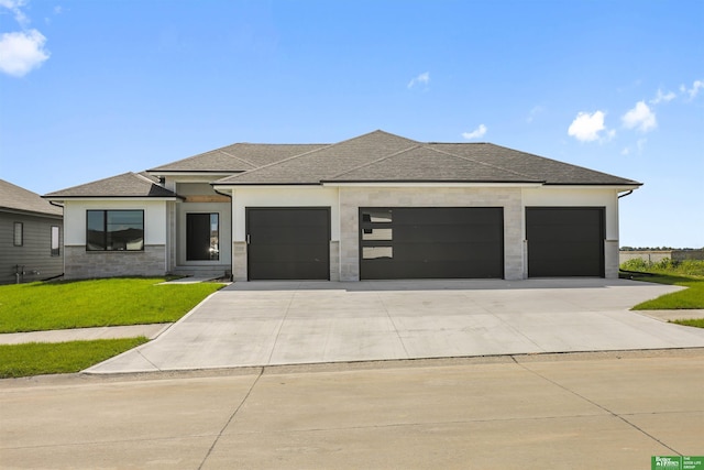 5508 N 212th St, Elkhorn, NE 68022 - prairie-style home featuring an attached garage, driveway, a front lawn, a shingled roof, and stucco siding