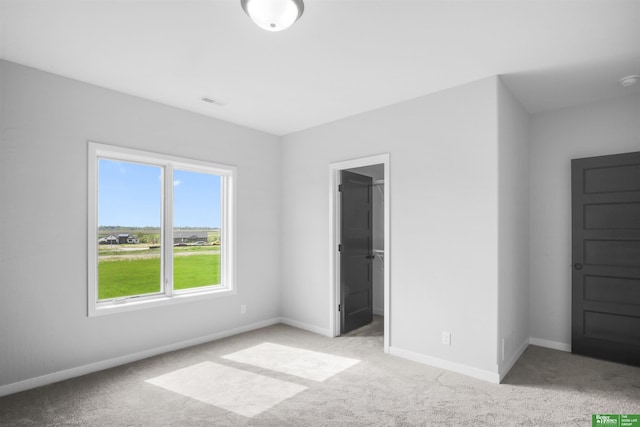 5508 N 212th St, Elkhorn, NE 68022 - unfurnished bedroom with light carpet, baseboards, and a spacious closet