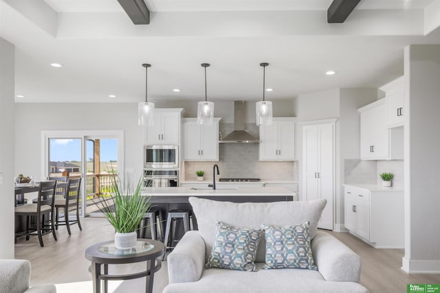 5508 N 212th St, Elkhorn, NE 68022 - living room featuring light wood-type flooring, recessed lighting, and beam ceiling