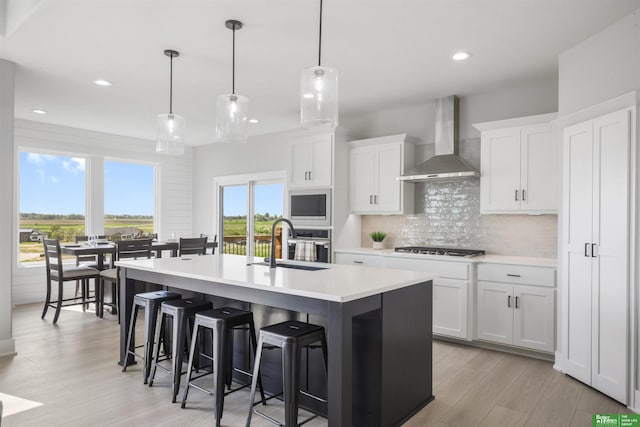 5508 N 212th St, Elkhorn, NE 68022 - kitchen with a sink, wall chimney exhaust hood, backsplash, light wood finished floors, and light countertops
