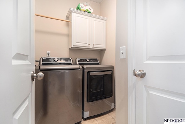 7409 N 160th St, Bennington, NE 68007 - washroom with washing machine and clothes dryer, cabinet space, and light tile patterned flooring