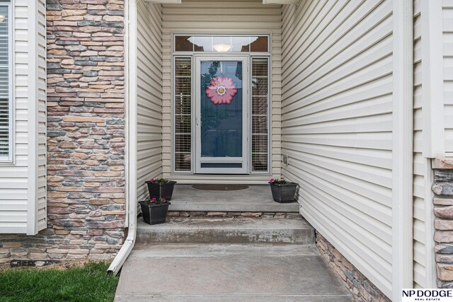 7409 N 160th St, Bennington, NE 68007 - doorway to property featuring stone siding