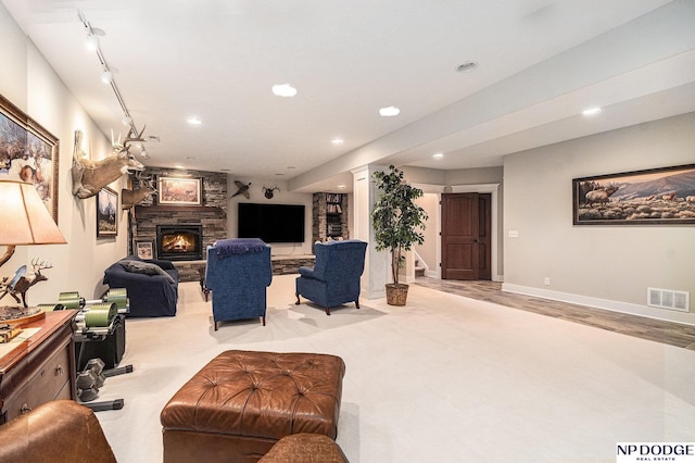 7409 N 160th St, Bennington, NE 68007 - carpeted living room with a fireplace, recessed lighting, baseboards, and stairway