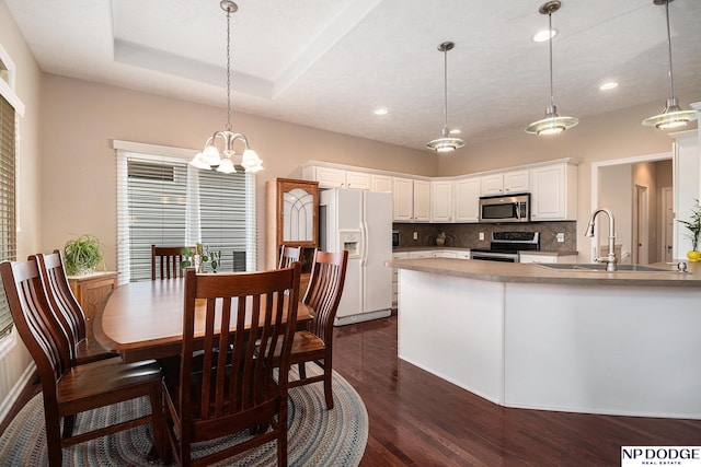 7409 N 160th St, Bennington, NE 68007 - dining space featuring dark wood-style floors, recessed lighting, and a chandelier