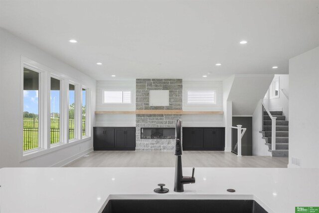5409 N 196th Ave, Elkhorn, NE 68022 - kitchen featuring a sink, recessed lighting, a stone fireplace, and wood finished floors