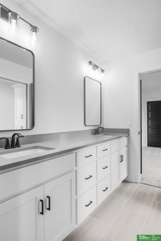 5409 N 196th Ave, Elkhorn, NE 68022 - bathroom featuring double vanity and a textured ceiling