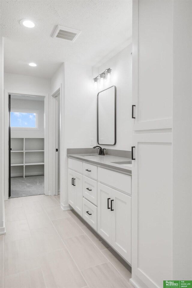 5409 N 196th Ave, Elkhorn, NE 68022 - full bath with double vanity, a textured ceiling, and recessed lighting