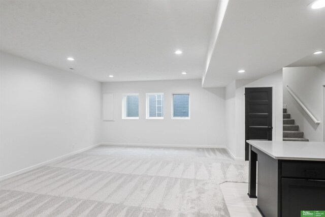 5409 N 196th Ave, Elkhorn, NE 68022 - below grade area featuring recessed lighting, light colored carpet, stairs, and baseboards