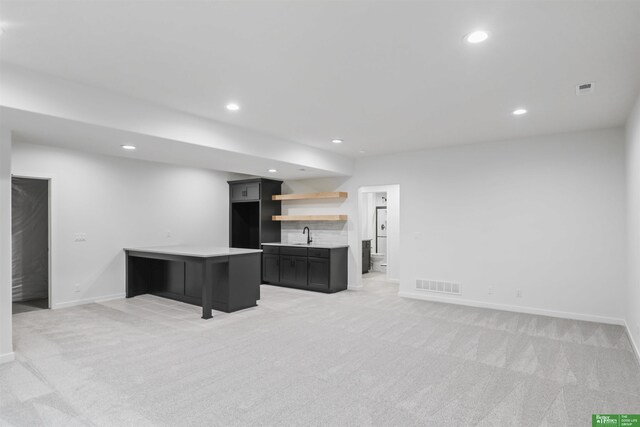 5409 N 196th Ave, Elkhorn, NE 68022 - unfurnished living room with recessed lighting, light carpet, baseboards, and bar with sink