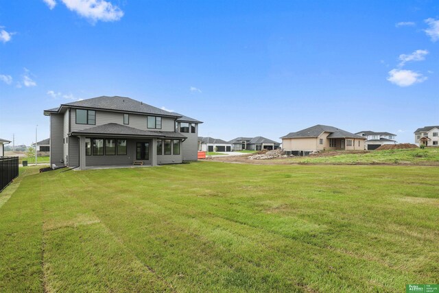 5409 N 196th Ave, Elkhorn, NE 68022 - rear view of house with a lawn, roof with shingles, and a residential view