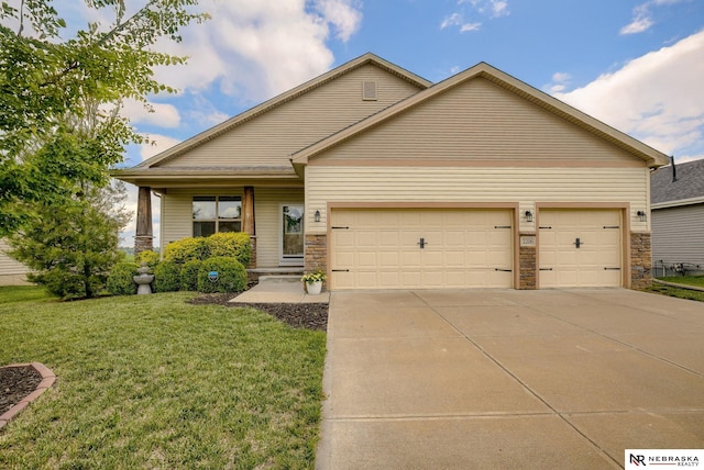 2206 Alexandra Rd, Papillion, NE 68133 - view of front of house featuring an attached garage, a front yard, driveway, and stone siding
