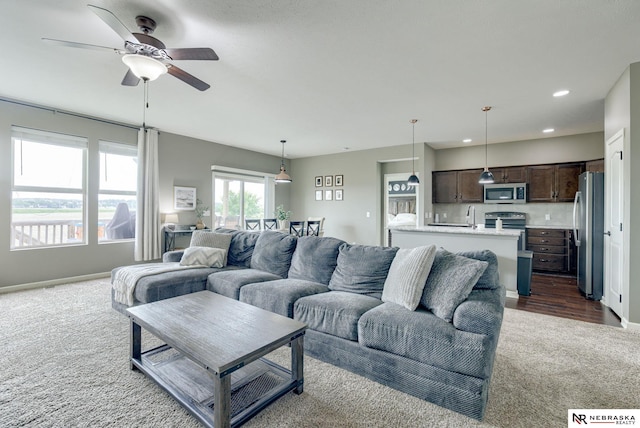 2206 Alexandra Rd, Papillion, NE 68133 - living area with dark colored carpet, a ceiling fan, recessed lighting, and baseboards