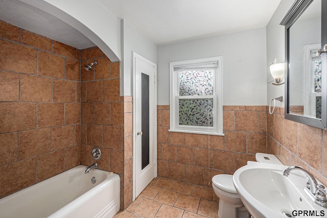 3519 N 53rd St, Omaha, NE 68104 - full bath with tile walls, a sink, shower / washtub combination, toilet, and a wainscoted wall