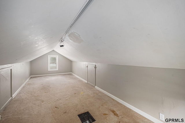 3519 N 53rd St, Omaha, NE 68104 - additional living space with vaulted ceiling, baseboards, and carpet flooring