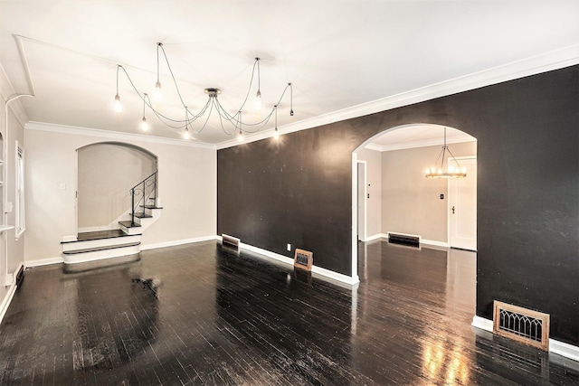 3519 N 53rd St, Omaha, NE 68104 - empty room with a chandelier, wood-type flooring, arched walkways, crown molding, and baseboards