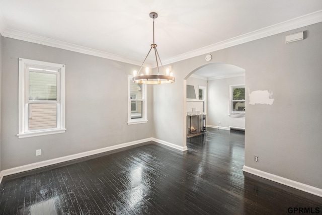 3519 N 53rd St, Omaha, NE 68104 - unfurnished room with dark wood-type flooring, baseboards, arched walkways, a chandelier, and crown molding