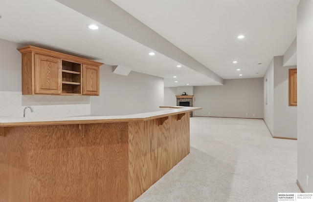 17616 Englewood St, Omaha, NE 68135 - bar with recessed lighting, light carpet, backsplash, baseboards, and a fireplace