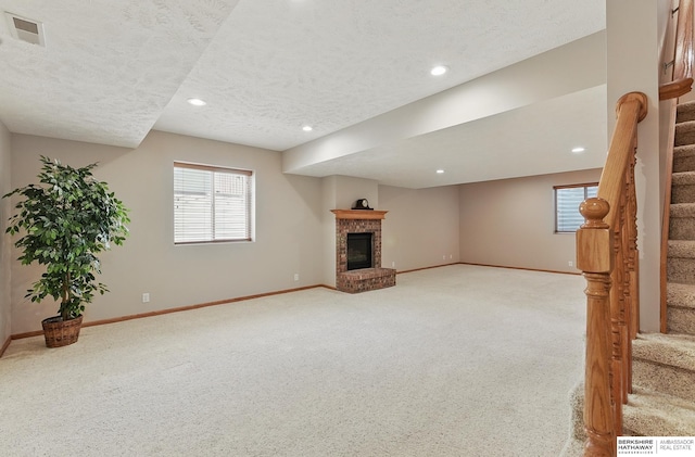 17616 Englewood St, Omaha, NE 68135 - unfurnished living room featuring stairway, light colored carpet, baseboards, recessed lighting, and a textured ceiling