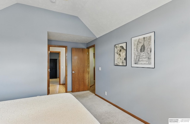 17616 Englewood St, Omaha, NE 68135 - bedroom featuring lofted ceiling, baseboards, and light colored carpet