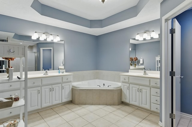 17616 Englewood St, Omaha, NE 68135 - bathroom with a bath, two vanities, tile patterned floors, and a raised ceiling