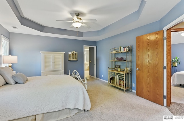 17616 Englewood St, Omaha, NE 68135 - bedroom featuring carpet, a tray ceiling, baseboards, ceiling fan, and ensuite bathroom
