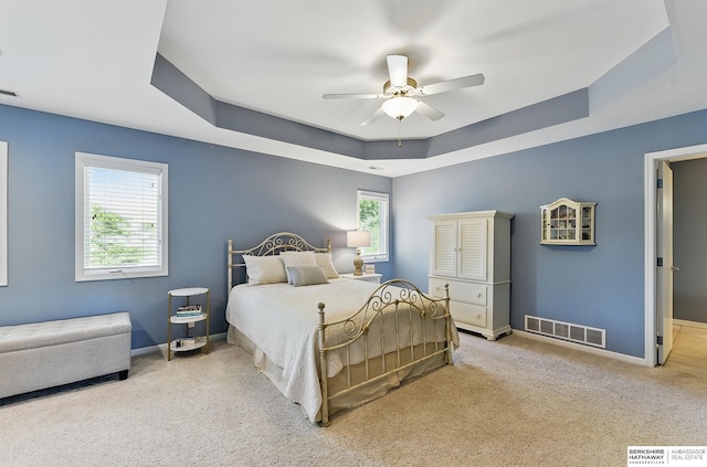 17616 Englewood St, Omaha, NE 68135 - carpeted bedroom featuring a tray ceiling, baseboards, and a ceiling fan
