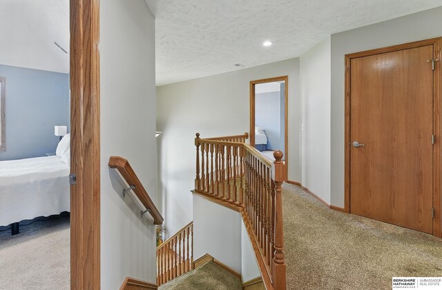 17616 Englewood St, Omaha, NE 68135 - hall with an upstairs landing, carpet flooring, a textured ceiling, and baseboards