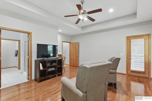 17616 Englewood St, Omaha, NE 68135 - living room with a ceiling fan, a tray ceiling, light wood finished floors, baseboards, and recessed lighting