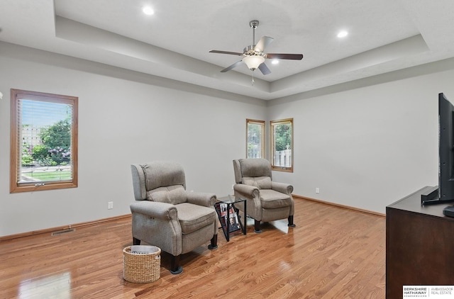 17616 Englewood St, Omaha, NE 68135 - living area with a ceiling fan, a tray ceiling, light wood-style flooring, baseboards, and recessed lighting