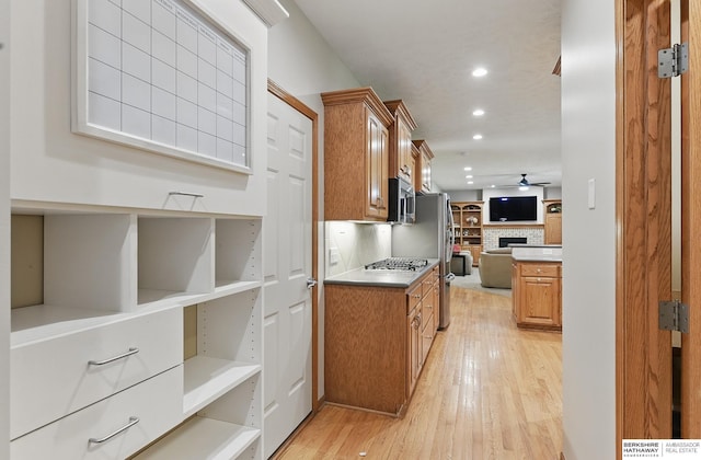 17616 Englewood St, Omaha, NE 68135 - kitchen featuring open floor plan, stainless steel appliances, recessed lighting, brown cabinetry, and light wood finished floors