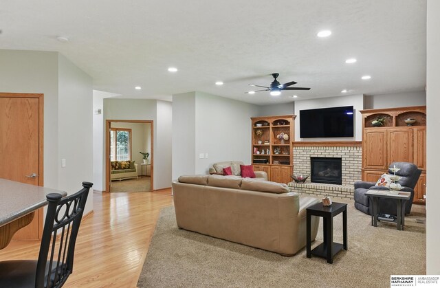 17616 Englewood St, Omaha, NE 68135 - living area featuring recessed lighting, a ceiling fan, light wood-style flooring, and a brick fireplace