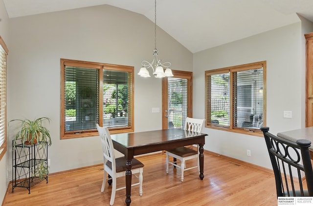 17616 Englewood St, Omaha, NE 68135 - dining space featuring vaulted ceiling, a chandelier, light wood-style floors, and baseboards