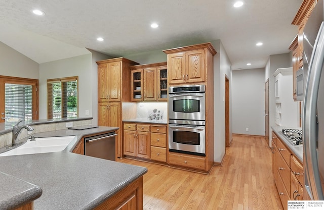 17616 Englewood St, Omaha, NE 68135 - kitchen featuring appliances with stainless steel finishes, a sink, recessed lighting, light wood-style floors, and vaulted ceiling