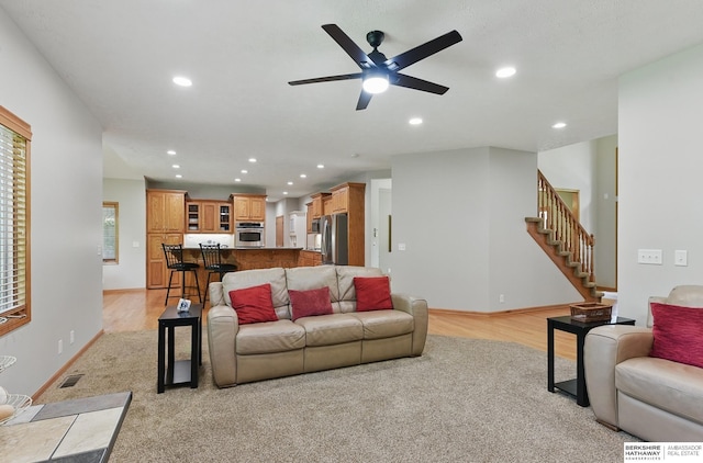 17616 Englewood St, Omaha, NE 68135 - living area featuring recessed lighting, a ceiling fan, stairway, light wood-style floors, and baseboards