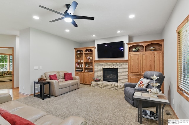 17616 Englewood St, Omaha, NE 68135 - living room with a fireplace, recessed lighting, ceiling fan, baseboards, and light carpet