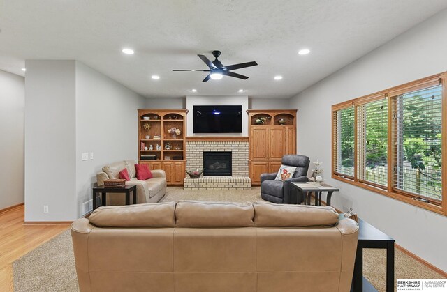 17616 Englewood St, Omaha, NE 68135 - living area featuring a ceiling fan, light wood-type flooring, baseboards, a brick fireplace, and recessed lighting