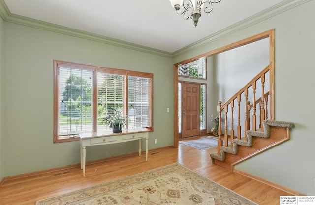 17616 Englewood St, Omaha, NE 68135 - entrance foyer featuring a chandelier, wood finished floors, crown molding, stairs, and baseboards