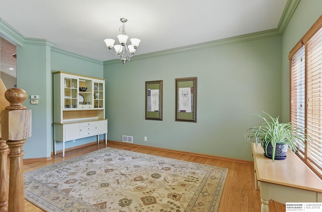 17616 Englewood St, Omaha, NE 68135 - dining room with a chandelier, crown molding, light wood-type flooring, and baseboards