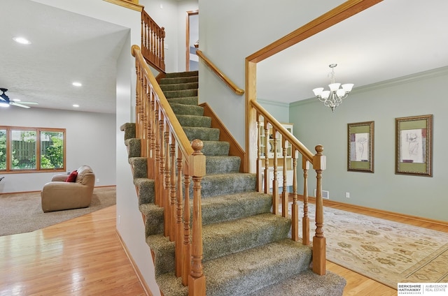 17616 Englewood St, Omaha, NE 68135 - staircase with wood finished floors, ceiling fan, recessed lighting, baseboards, and a chandelier