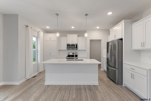 17312 Potter St, Bennington, NE 68005 - kitchen featuring appliances with stainless steel finishes, a sink, light countertops, white cabinets, and light wood finished floors