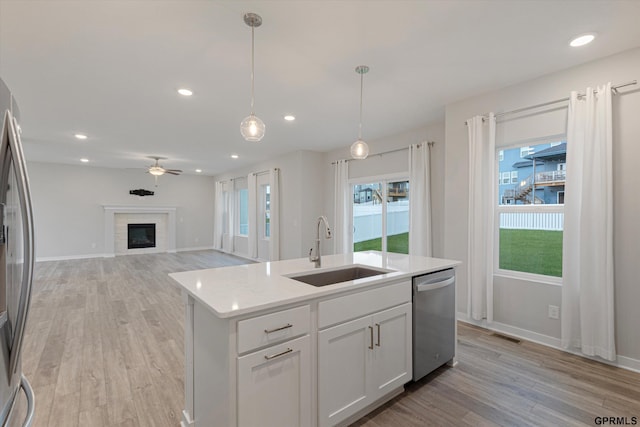 17312 Potter St, Bennington, NE 68005 - kitchen with stainless steel appliances, a sink, light wood-style flooring, plenty of natural light, and recessed lighting