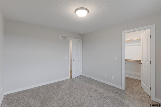 17312 Potter St, Bennington, NE 68005 - unfurnished bedroom featuring carpet, baseboards, a walk in closet, and a closet