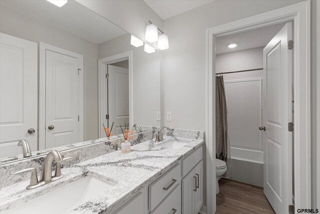 17312 Potter St, Bennington, NE 68005 - full bathroom featuring toilet, double vanity, shower / bath combo, and wood finished floors